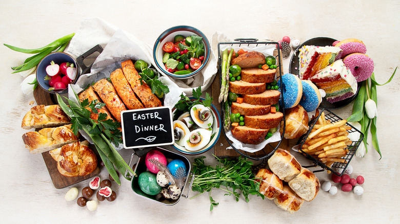 Alimentos de Pascua con hierbas frescas a su alrededor.