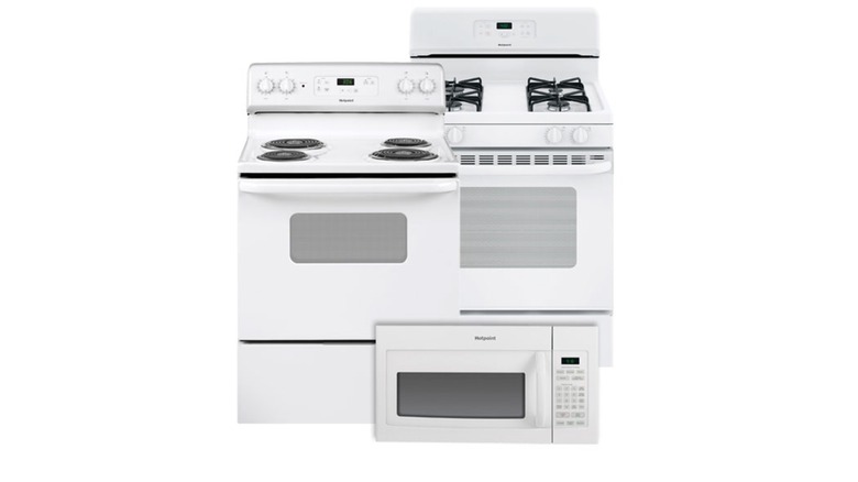Dos unidades de estufa/horno de color blanco liso y un microondas de color blanco liso