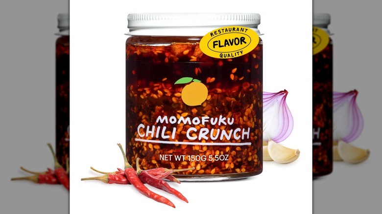 Un frasco de aceite crujiente de chile Momofuku sobre un fondo blanco.