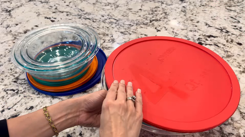 Mujer cerrando la tapa de un juego de Pyrex